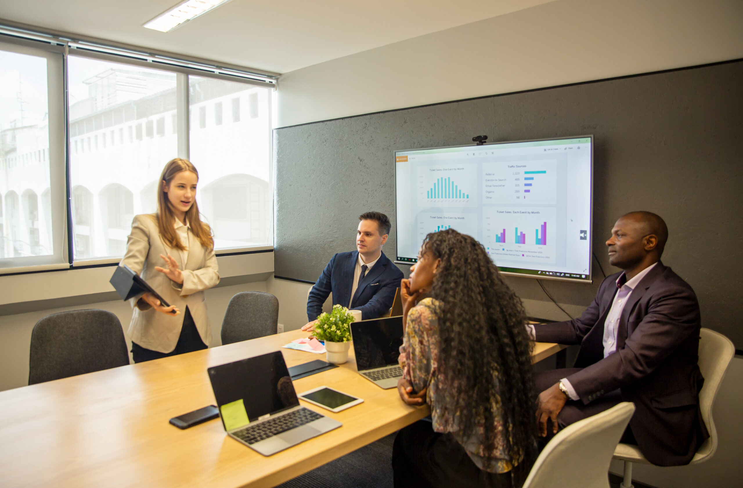 A young business professional delivering a proposal to clients in person.